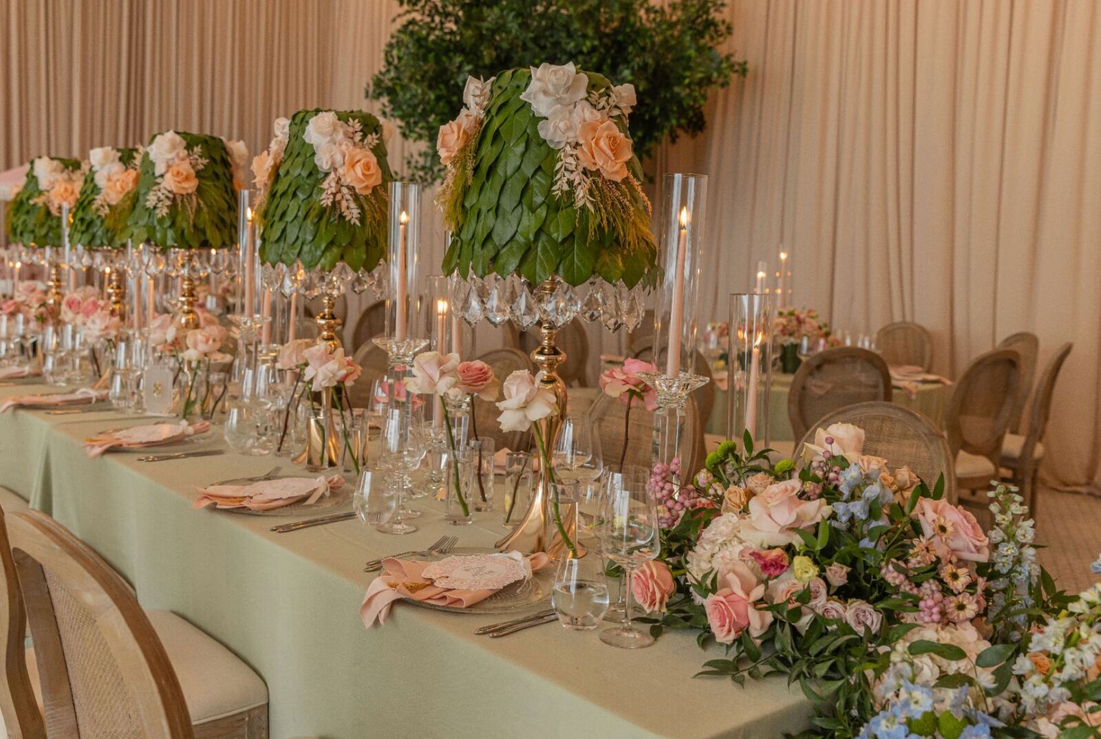 Leaf Lampshade Centerpieces - Sculptural leaf-and-rose lampshades with crystal candelabras along a sage tablescape by Aura Floral Design Miami