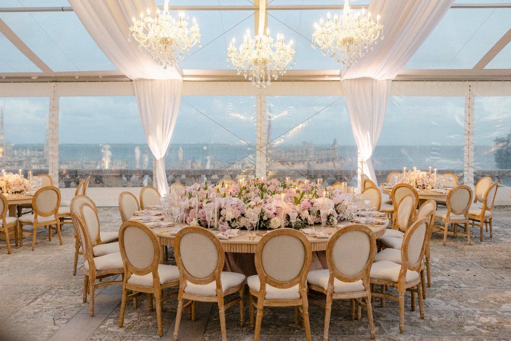 Crystal Pavilion - Glass tent with chandeliers and lush centerpieces by Aura Floral Design Miami