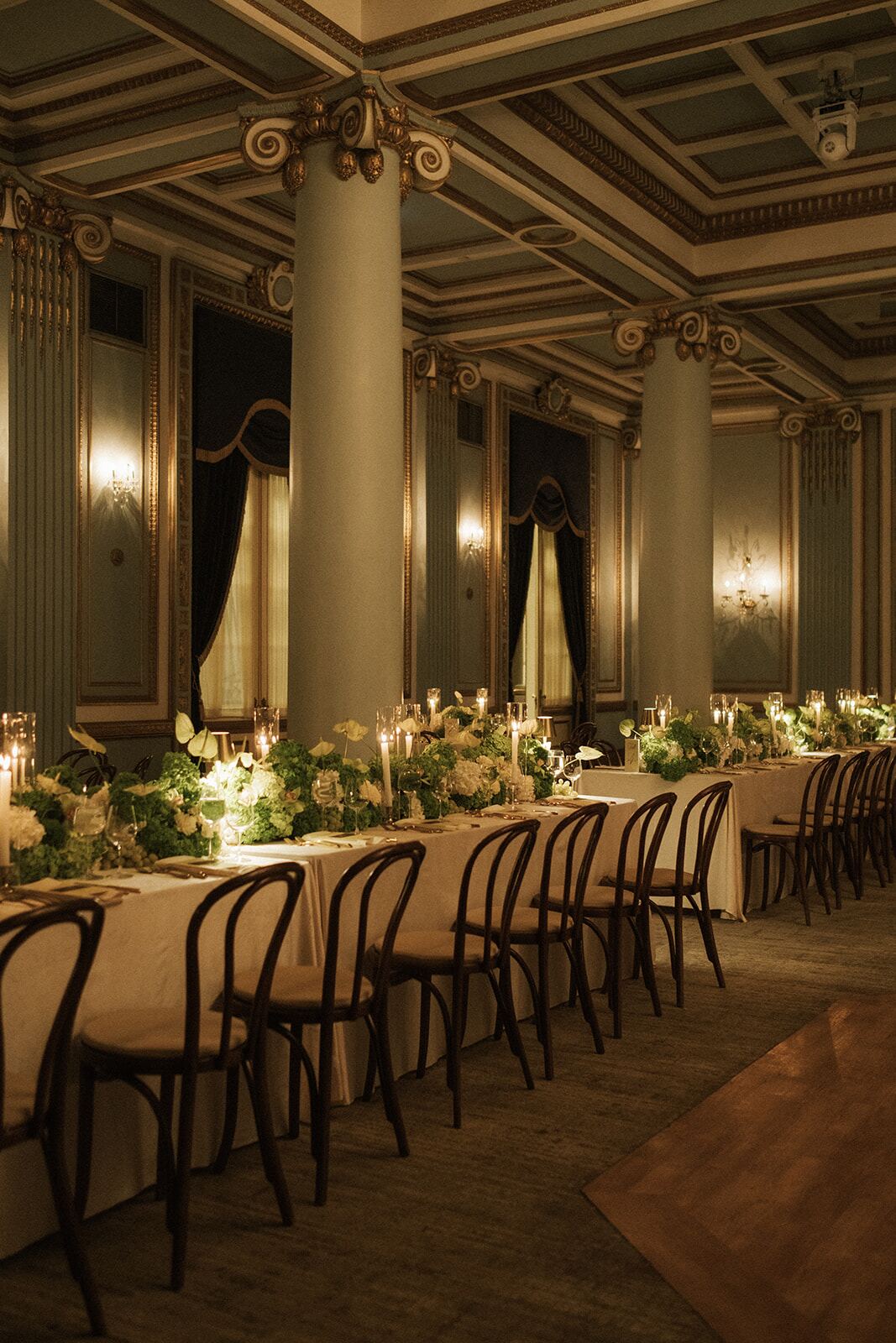 Heritage Ballroom Tablescape - Long ivory tables with greenery garlands and taper candles in a gilded ballroom by Aura Floral Design Miami